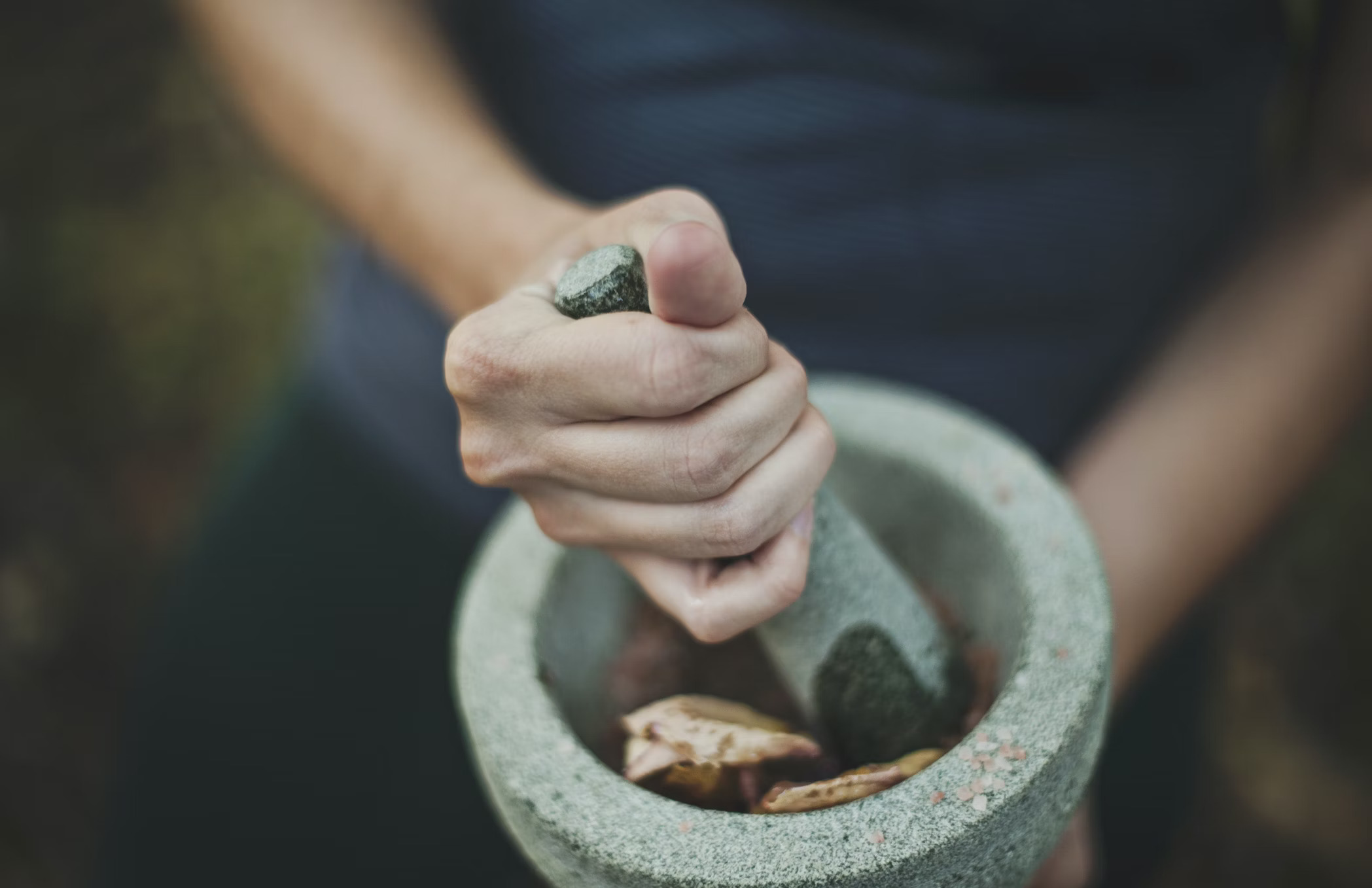 Image of a person grinding spices.