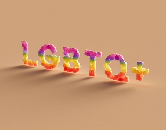 LGBTQ+ letters on a pastel background