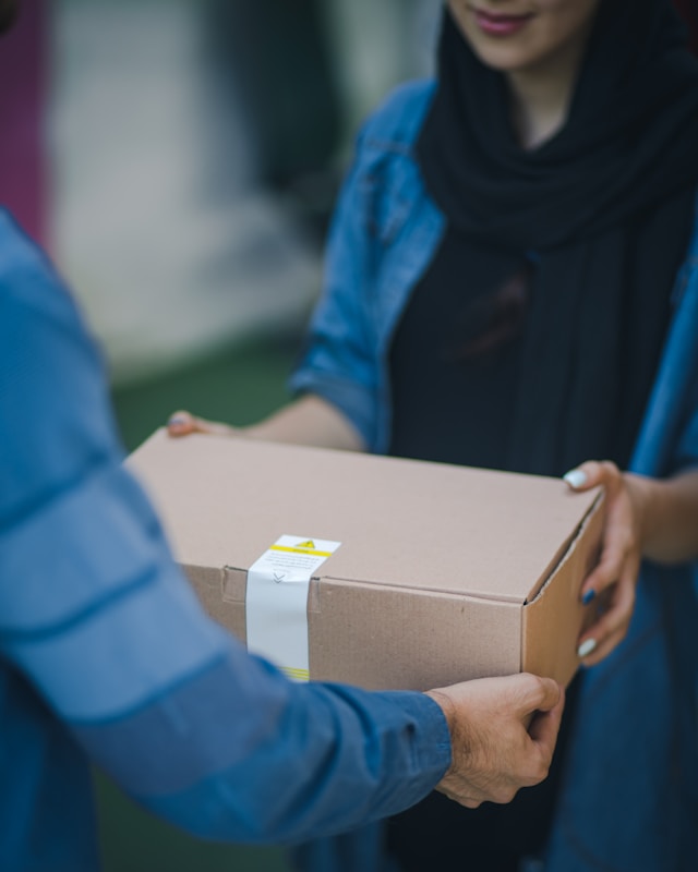 Person giving brown box