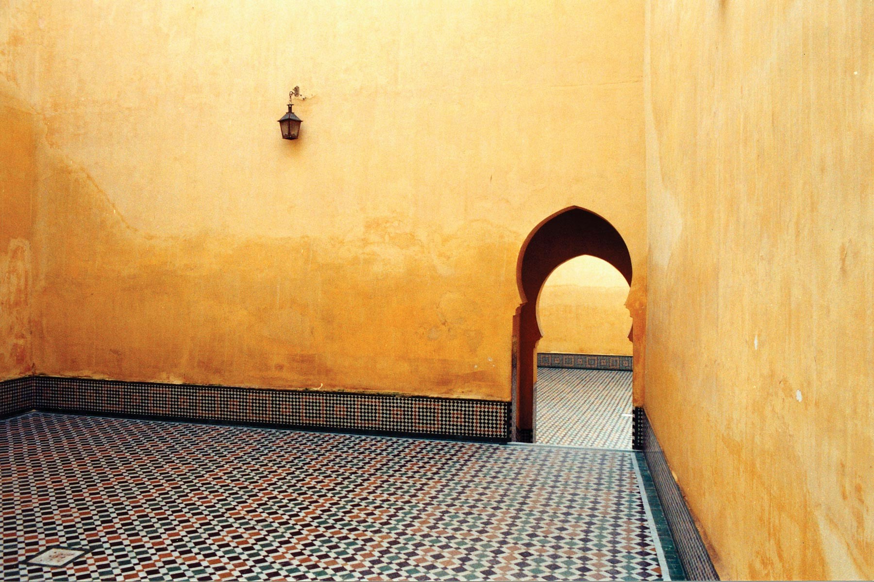 Yellow concrete wall with a doorway.