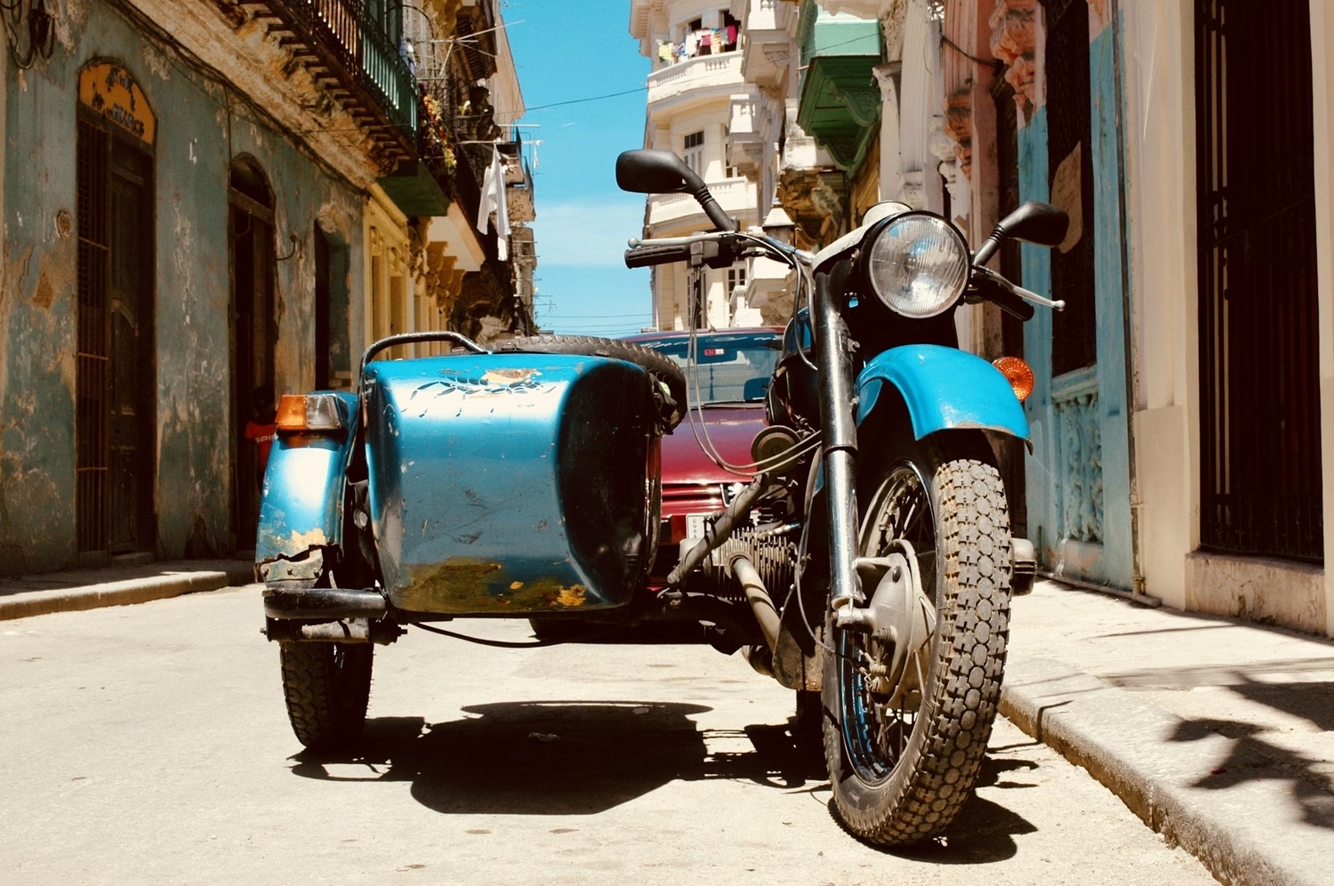 A motorbike with a sidecar - street scene of Havana, Cuba