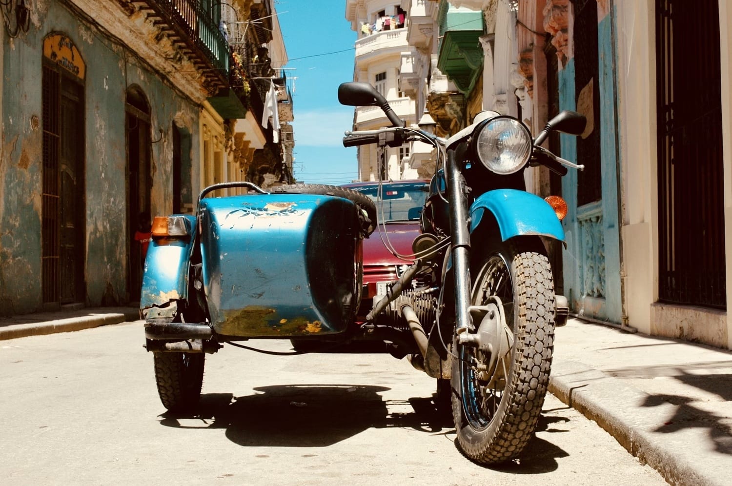 A motorbike with a sidecar - street scene of Havana, Cuba