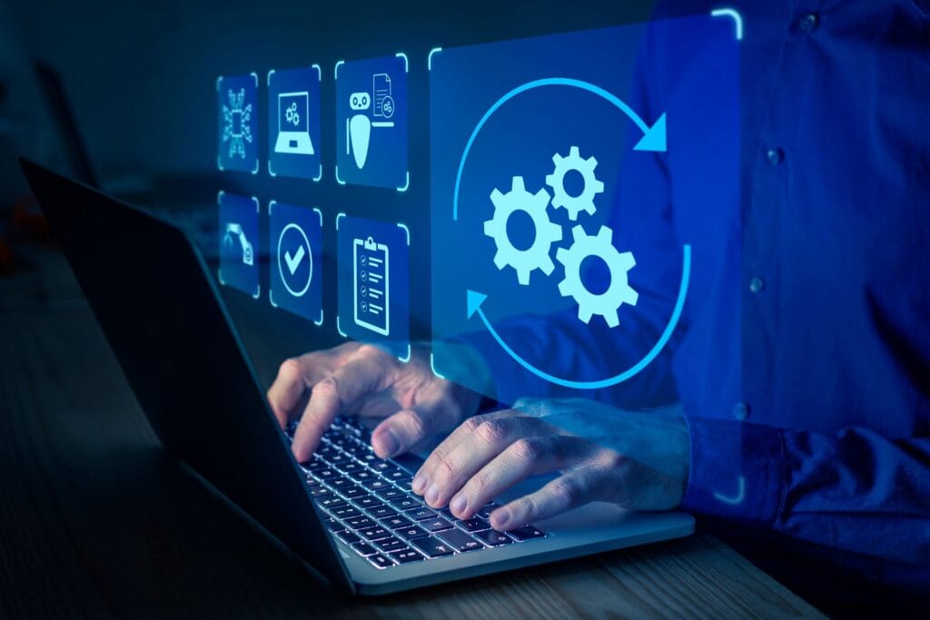 an automation icon floating above someone using a laptop