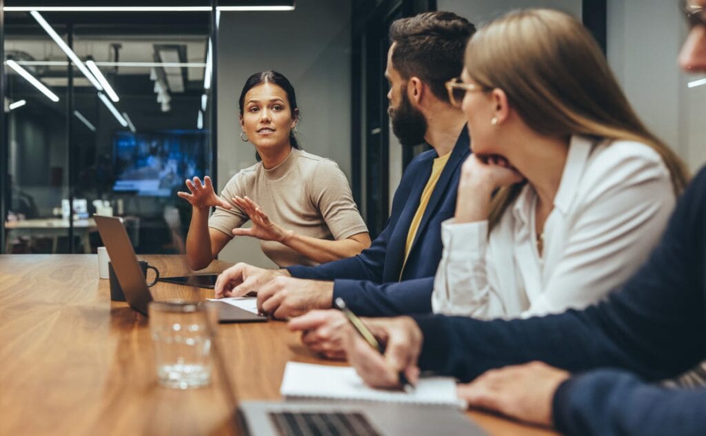 woman speaking with her colleagues at a meeting